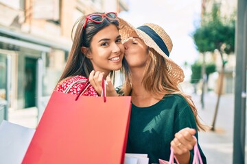 Canvas Print - Beautiful hispanic mother and daughter smiling happy and shopping at the city.