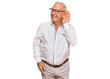 © Krakenimages.com - Senior caucasian man wearing business shirt and glasses smiling with hand over ear listening an hearing to rumor or gossip. deafness concept.