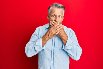 Canvas Print - Middle age grey-haired man wearing casual clothes shocked covering mouth with hands for mistake. secret concept.