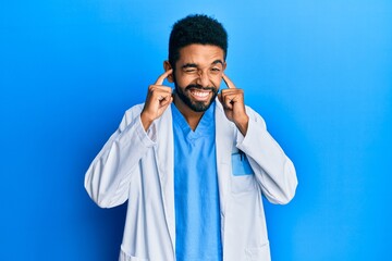 Sticker - Handsome hispanic man with beard wearing doctor uniform covering ears with fingers with annoyed expression for the noise of loud music. deaf concept.