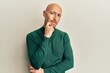 © Krakenimages.com - Bald man with beard wearing casual turtleneck sweater thinking concentrated about doubt with finger on chin and looking up wondering