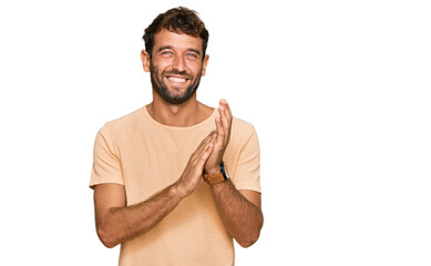 Poster - Handsome young man with beard wearing casual tshirt clapping and applauding happy and joyful, smiling proud hands together