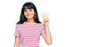 © Krakenimages.com - Young hispanic girl wearing casual clothes showing and pointing up with fingers number three while smiling confident and happy.