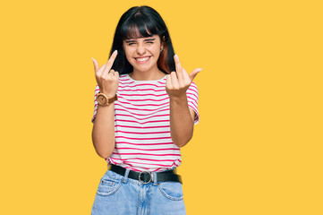 Young hispanic girl wearing casual clothes showing middle finger doing fuck you bad expression, provocation and rude attitude. screaming excited