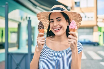 Wall Mural - Young latin tourist girl on vacation smiling happy eating ice cream at the city.