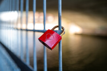  Red Padlock On Which Is Engraved A Heart Hangs On A Fence