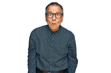 Poster - Middle age indian man wearing casual clothes and glasses making fish face with lips, crazy and comical gesture. funny expression.