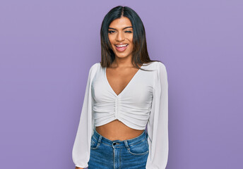 Young latin transsexual transgender woman wearing casual clothes winking looking at the camera with sexy expression, cheerful and happy face.