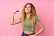 © luismolinero - Young blonde woman with curly hair isolated on pink background doing strong gesture