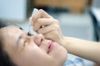 © pongmoji - Woman use eye drop, artificial tears to the eye