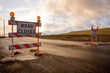 © Scope Images - Closed road signs on an empty and deserted  road with bleak sky