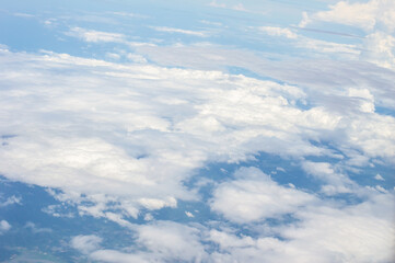 Wall Mural - over the clouds,Blue sky with tiny clouds background Beautiful natural view from airplane window above. Background or Wallpaper.blue sky and cloud sky nature.Top view of aircraft