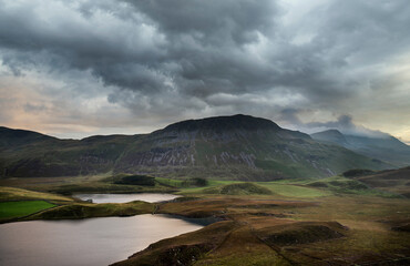 Wall Mural - Stunning Summer dawn over mountain range with lake and beautiful sky