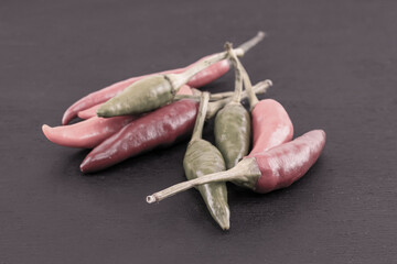 set of mini pods of hot pepper red and green on a black background