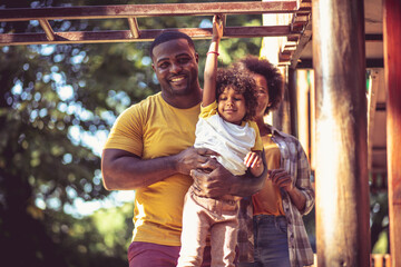  African American family having fun in park.