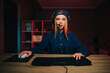 © bodnarphoto - Surprised female gamer in a cap and headset plays video games at home on the computer and looks at the screen with a shocked face. Online games at night.