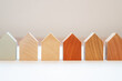 a set of small wooden houses in a row. home buying concept