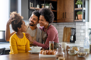 Wall Mural - happy black family smiling in kitchen. casual bonding