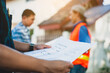 © Wasan - The contractor holds the construction project plan.