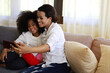 © Watercolor_Concept - American kid girl smile portrait and selfie photo with mother at home.