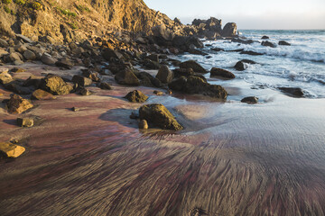 Wall Mural - Colorful sand and scattered rocks on Pfeiffer Beach in Big Sur, California