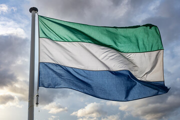 Wall Mural - Sierra Leone flag waving against cloudy sky