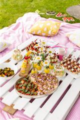 Outdoor picnic party, variety food on blanket