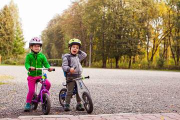 Wall Mural - Sweet kids on balance bikes outdoors at the park