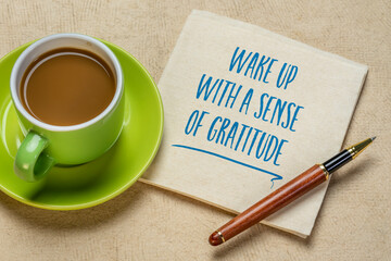 Wall Mural - wake up with a sense of gratitude inspirational handwriting on a napkin with a cup of coffee, positivity and personal development concept