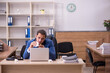 © Elnur - Young sick businessman employee suffering at workplace