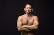 © Эльвира Кулешова - Handsome smiling man on the black background. Muscular and athletic. Man portrait. Male model in studio