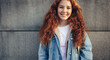 © Jacob Lund - Cheerful student standing against wall background