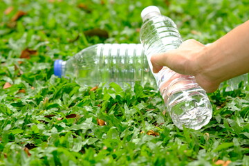 Sticker - bottle of water in green natural background and space