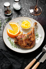 Wall Mural - Duck leg confit served with potato chips and mustard sauce .Traditional french cuisine.