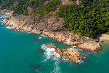 Poster - Top down view of the ocean wave crash on the island cliff