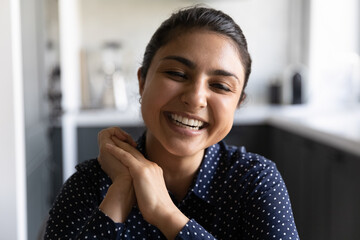 Head shot portrait close up smiling Indian woman making video call, looking at camera, overjoyed young female speaking, chatting online, happy blogger influencer recording vlog, having fun