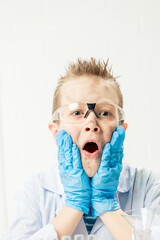 Wall Mural - funny boy dressed as chemist with dirty face after a failed experiment