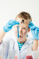 Wall Mural - funny boy dressed as chemist with dirty face after a failed experiment