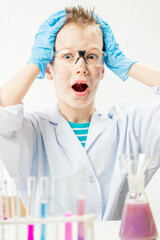 Wall Mural - funny boy dressed as chemist with dirty face after a failed experiment