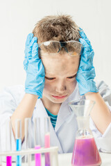 Wall Mural - funny boy dressed as chemist with dirty face after a failed experiment