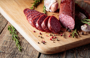 Smoked salami on a old wooden table.