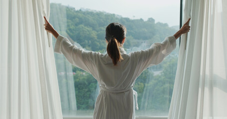 Canvas Print - Woman open the curtain at morning