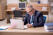 © Elnur - Old businessman employee sitting at workplace