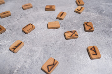 Scandinavian magic runes made of oak on concrete