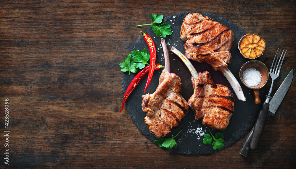 Grilled veal meat ribs cutlets with ingredients on wooden table - obrazy, fototapety, plakaty 
