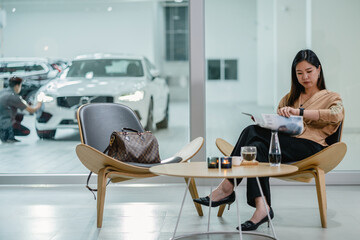 Asian mechanic explaining the check list of maintainance service to customer in showroom