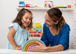 © Brian Díaz - Two-year-old girl and her young kindergarten teacher, playing and learning in kindergarten.