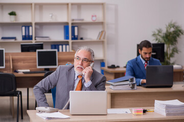 Two male employees working in the office