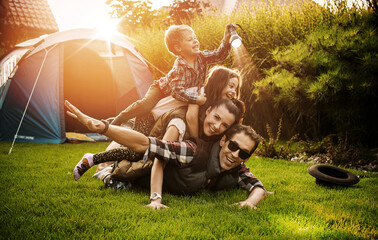 cheerful family realxing on a camp
