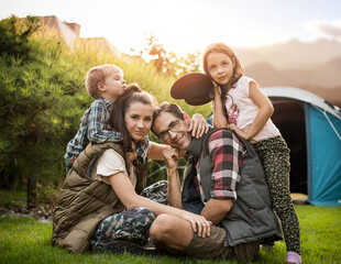 Cheerful family realxing on a camp